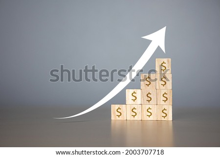 concept of increasing profits in business. Wooden blocks with Icon percentage symbol and arrow pointing up, economy is improving.