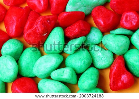 red and green pebbles on yellow background
