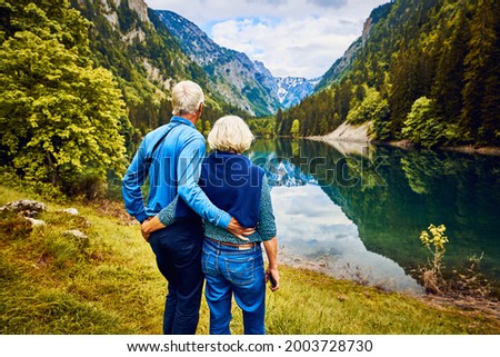 Couple of active seniors enjoying lake view on Susicko jezero on Durmitor national park in montenegro senior couple in nature active seniors on mountain lake