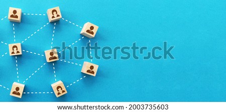 Teamwork, network and community concept, wooden blocks with business people icon on blue background