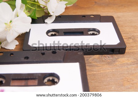 Audio cassette and spring flowers on a wooden table