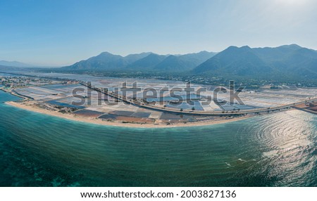 Drone view of Ca Na salt farm in daylight. It's by the coastline road of Ninh Thuan province, central Vietnam Royalty-Free Stock Photo #2003827136