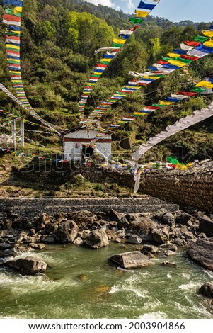 ancient holy iron bridge with many buddhist holy flags from flat angle image is taken at chaksam bridge tawang arunachal pradesh india.