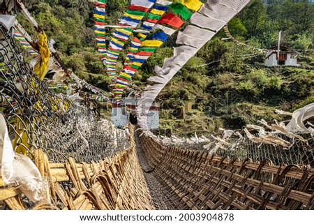 ancient holy bamboo bridge with many buddhist holy flags from unique perspective image is taken at chaksam bridge tawang arunachal pradesh india.