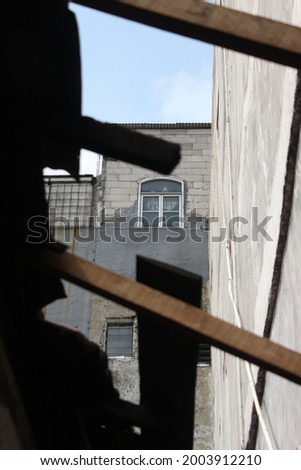 picture of Tall building window, taken from Old House near of it 