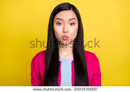 Photo of lovely brunette hair young lady blow kiss wear pink sweater isolated on yellow background