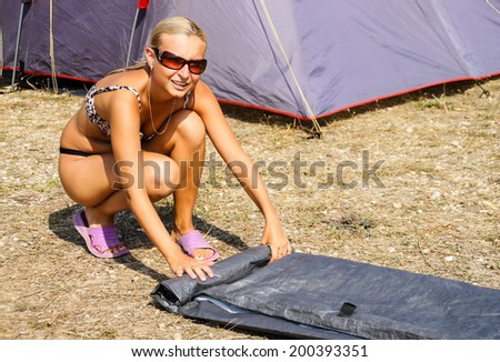 Girl braids an awning from tent