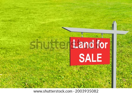 Land for sale sign illustration design over a green background. Three-dimensional land for sale sign. A green farm field behind a street sign. Land for sale logo on red signboard