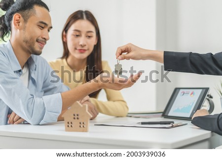 Happy asian couple client, tenant buy home ,apartment. Realtor holding key chain giving new landlord after sign signature contract rental purchase, bank approve mortgage, loan. Property of financial.