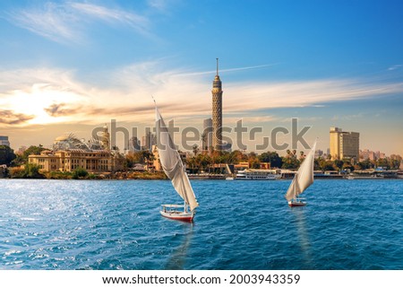 The Nile and feluccas in front of the Tower of Cairo, Egypt Royalty-Free Stock Photo #2003943359
