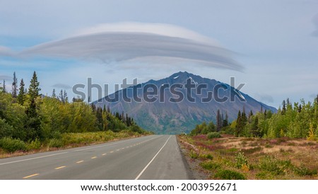 Canada, Yukon. Lenticular cloud over mountain on the Haines Highway. Royalty-Free Stock Photo #2003952671