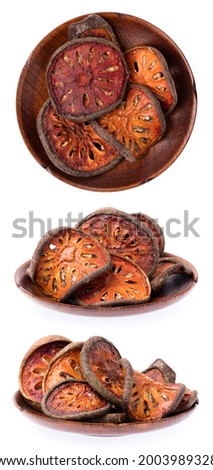 Set of Dried bael fruit, quince slices on dish isolated on a white background