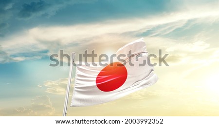 Japan national flag waving in beautiful clouds.