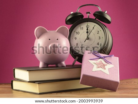 A concept of saving money to buy yourself a gift using a piggy bank and present.