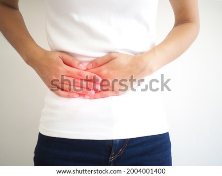 Woman suffering abdominal pain on the side due to salpingitis. closeup photo, blurred. Royalty-Free Stock Photo #2004001400