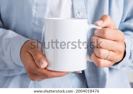 White coffee mug in the hands of the girl for presentation custom sublimation print. Blank mug photo mockup template Royalty-Free Stock Photo #2004018476