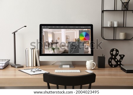 Designer's workplace. Computer with photo editor application on table indoors
