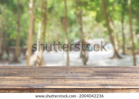 wood table top on blur beach and palm trees background