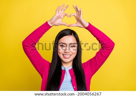 Photo of sweet brunette hair millennial lady show heart wear pink sweater isolated on yellow color background