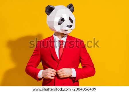 Photo of businessman panda guy adjust button look empty space wear mask red suit tie isolated on yellow color background