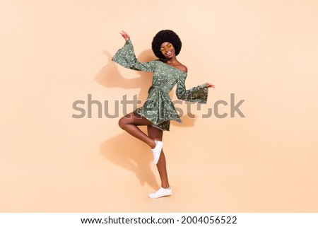 Full body profile side photo of young excited black girl happy positive smile wear dress isolated over beige color background
