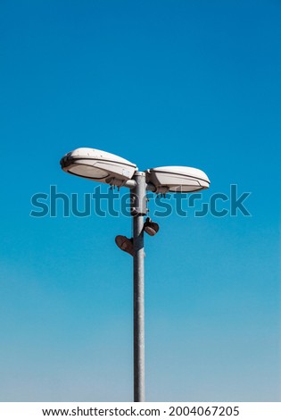 light pole with tennis in the blue sky