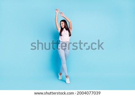 Full body photo of young attractive asian girl happy positive smile hands up elegant isolated over blue color background