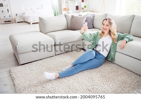 Full body profile side photo of young woman happy positive smile sit floor make selfie cellphone video call indoors