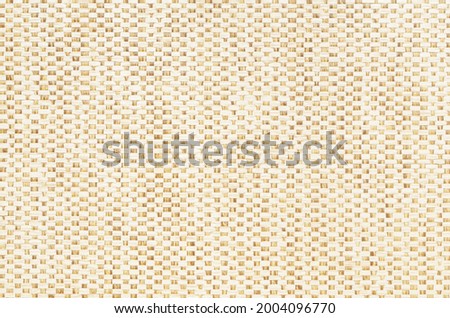 Brown beige mesh textile background. Texture of fabric with wood bark woven in a grid pattern
