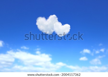 Blue sky with two heart-shaped clouds. Royalty-Free Stock Photo #2004117362