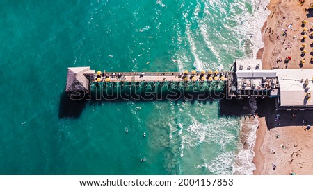 Amazing aerial picture of the Cocoa Beach Pier located in Florida with blue sea