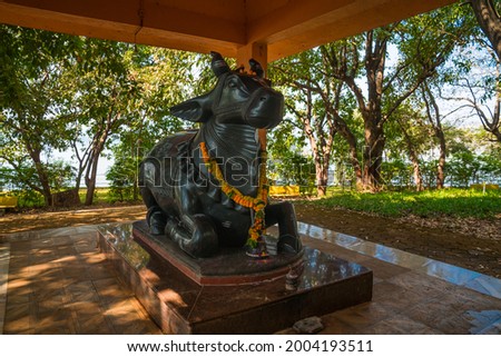 Statue of a black cow God known as Nandi in an outdoor park