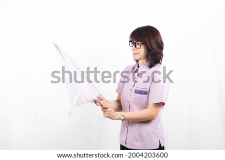 Woman in office holding umbrella