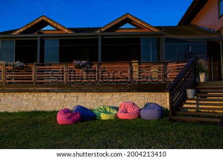 Multi-colored beanbag chairs on the lawn for relaxation. Modern outdoor furniture 