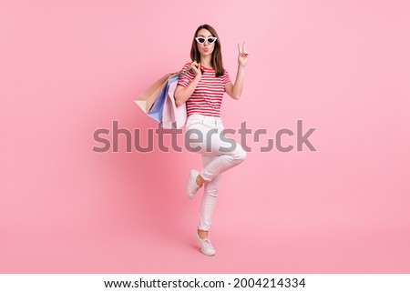 Full body photo of young girl pouted lips send air show peace cool v-sign isolated over pink color background
