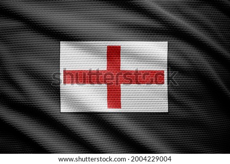 England flag isolated on black jersey. National symbols of England.
