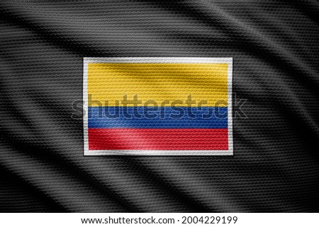 Colombia flag isolated on black jersey. National symbols of Colombia.