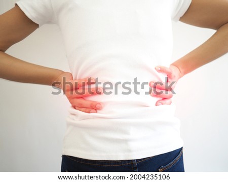 Woman back pain and lumbar pain caused by pyelonephritis, kidney stones, polycystic kidney disease, glomerulonephritis and Chronic renal failure. healthcare concept. closeup photo, blurred. Royalty-Free Stock Photo #2004235106