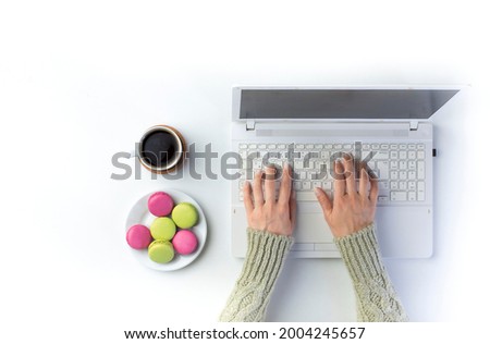 Top view businesswoman hands on empty white desk in the office with laptop. 
