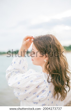 Young beautiful pregnant woman in a beautiful dress near the sea. Picnic.