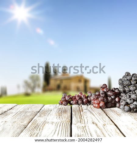 White wooden desk of free space and fresh red grapes fruits 