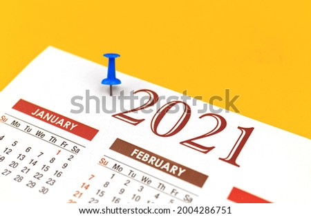 2021 Calendar with push pin, organizer and planner concept, closeup and selective focus photo
