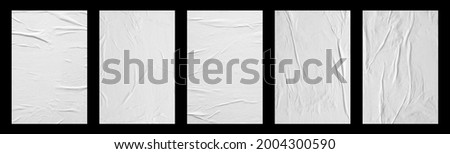 white crumpled and creased glued paper poster set isolated on black background Royalty-Free Stock Photo #2004300590