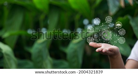 Technology, hand holding with environment Icons over the Network connection on green background.