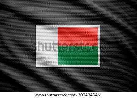 Madagascar flag isolated on black jersey. National symbols of Madagascar.