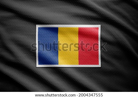 Romania flag isolated on black jersey. National symbols of Romania.