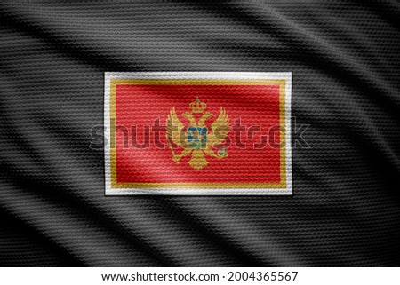 Montenegro flag isolated on black jersey. National symbols of Montenegro.