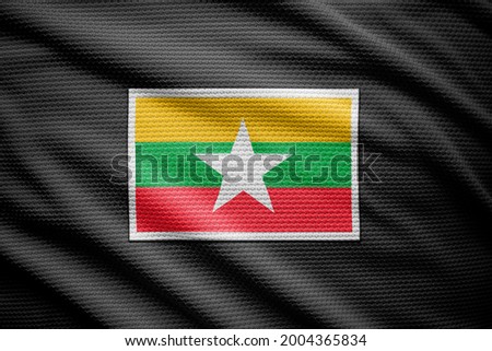 Myanmar flag isolated on black jersey. National symbols of Myanmar.