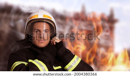 Rescuer wearing uniform and helmet. Professional firefighter