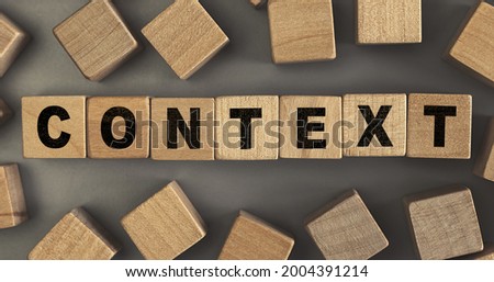 The word CONTEXT on small wooden blocks at the desk. Conceptual photo. Top view
